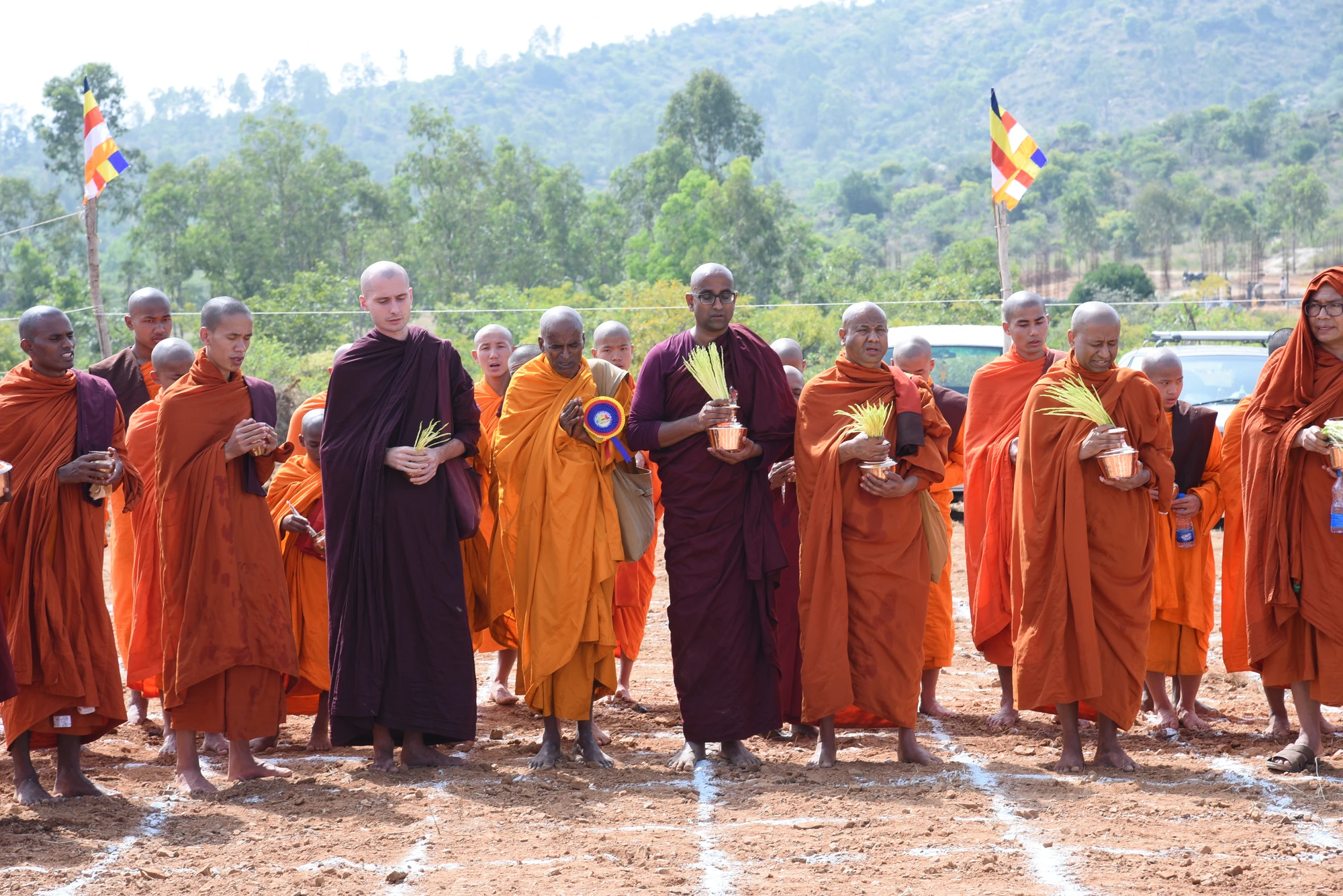 Monastics assembled with offerings during a ground blessing